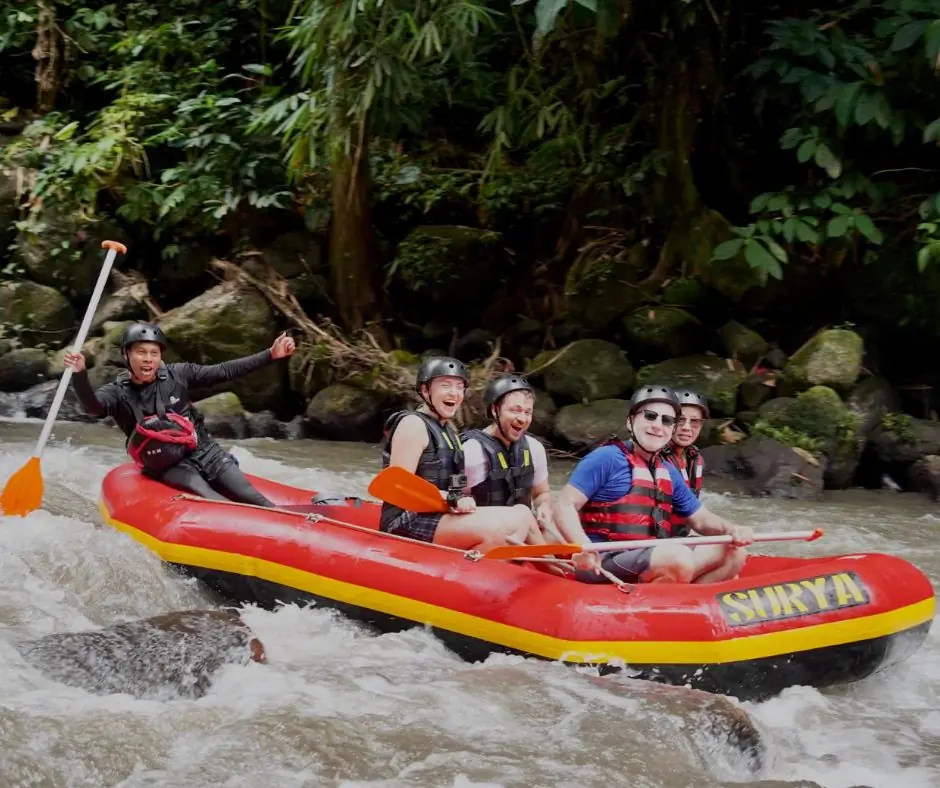 Smiling guests rafting through Ayung River rapids with Surya Bintang Adventures