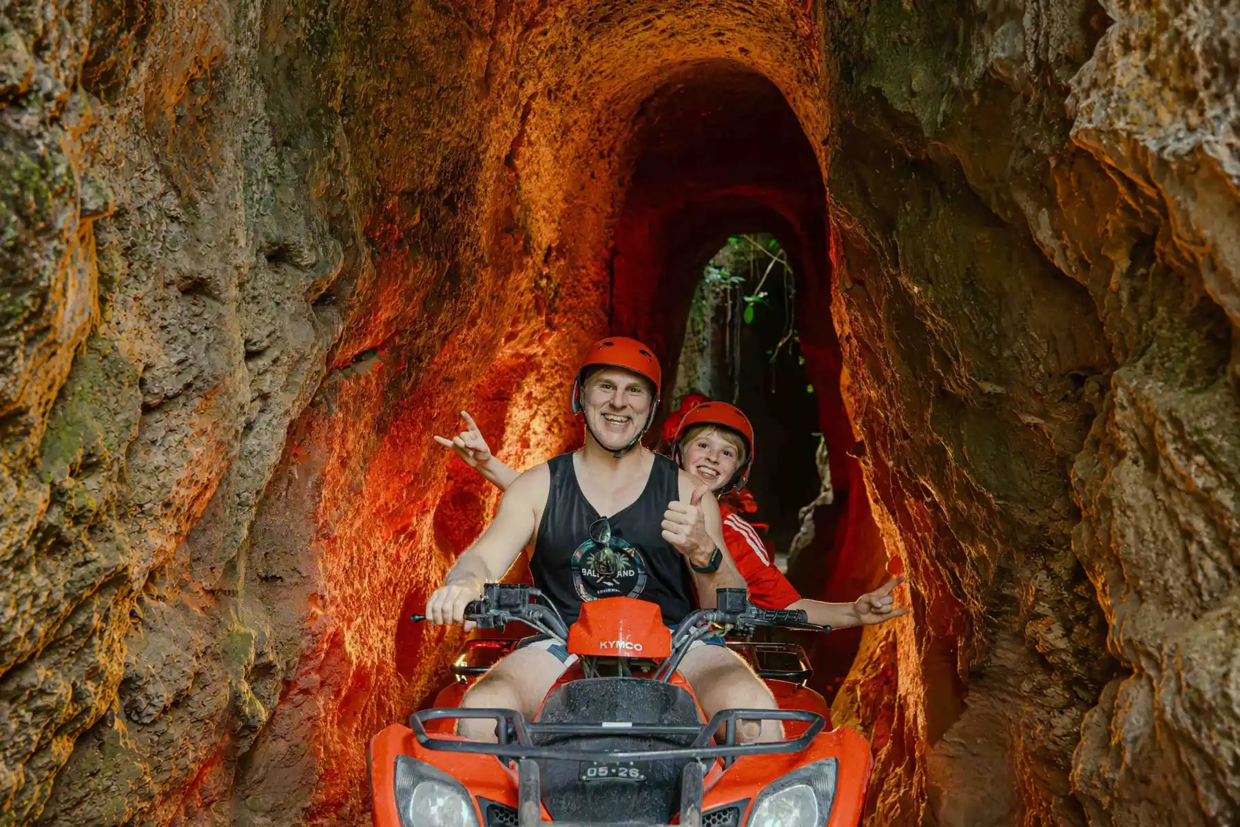 Adult and child on a tandem ATV inside the Kuber cave